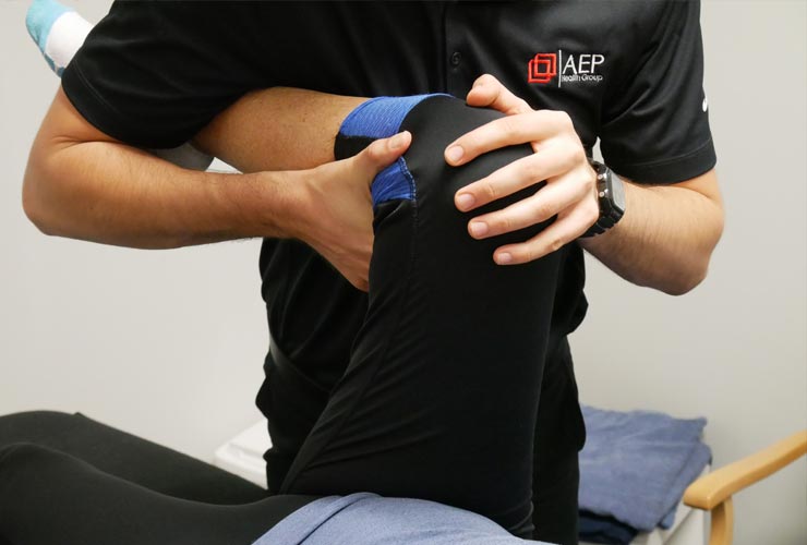 Physiotherapist checks knee mobility